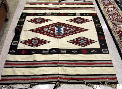 Appraisal: A LARGE NAVAJO RUG hand woven with four central serrated