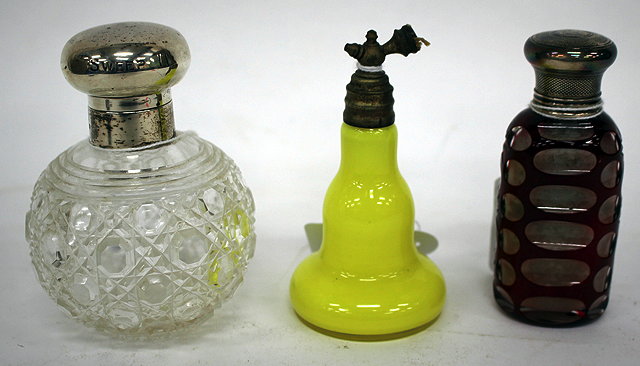 Appraisal: A WHITE METAL TOPPED PERFUME BOTTLE in clear and red