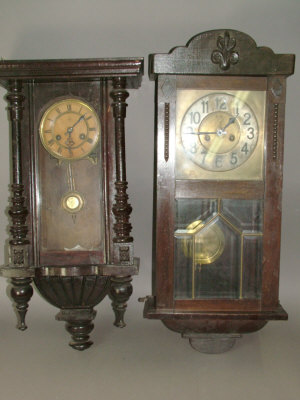 Appraisal: A Continental wooden cased regulator type wall clock with turned