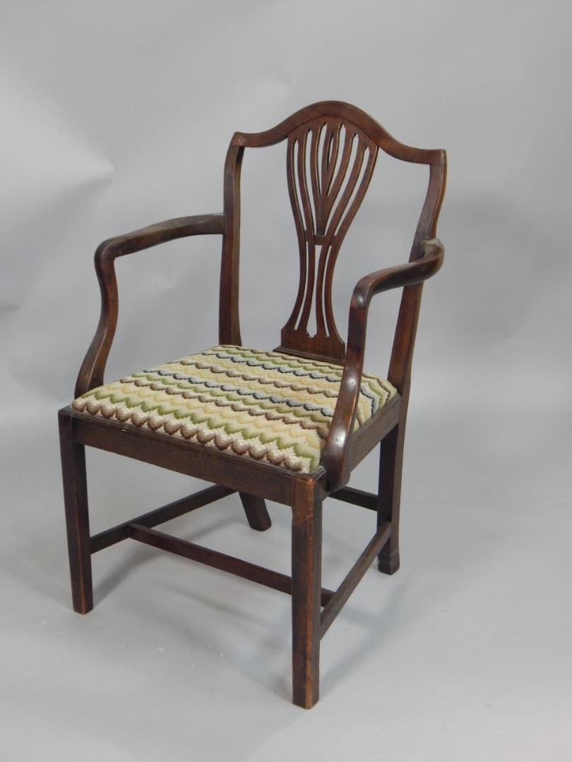 Appraisal: A thC mahogany open armchair with a pierced splat drop