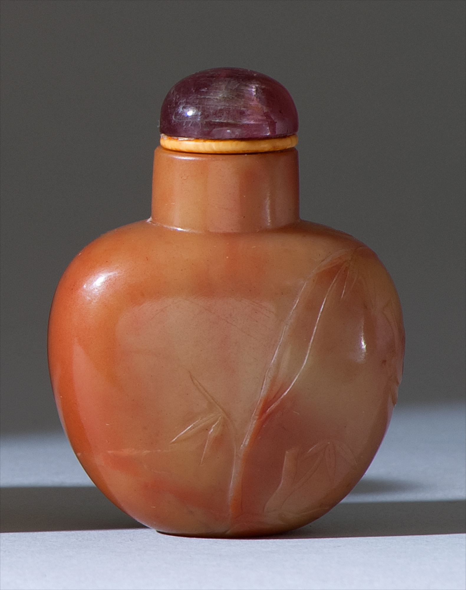 Appraisal: CARNELIAN SNUFF BOTTLE th CenturyIn ovoid form with bird prunus