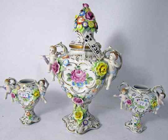 Appraisal: A Trio of Porcelain Floral Vases with Cupids Largest cm