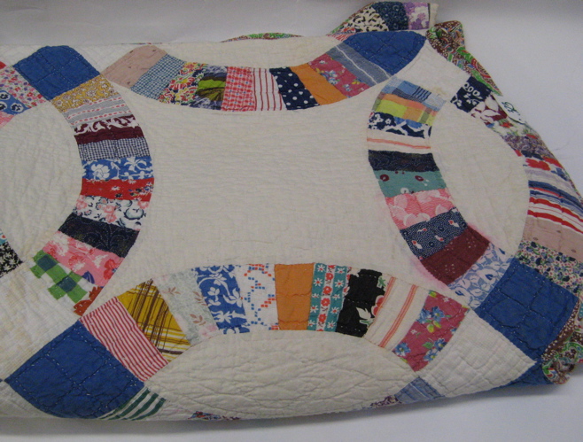 Appraisal: AMERICAN HANDMADE AND QUILTED PATCHWORK QUILT in a Double Wedding