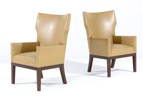 Appraisal: CHRISTIAN LIAGRE Pair of mahogany wing-back armchairs upholstered in tan