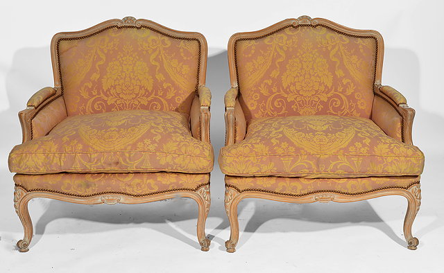 Appraisal: A PAIR OF LIMED BEECH UPHOLSTERED ARMCHAIRS with cabriole front