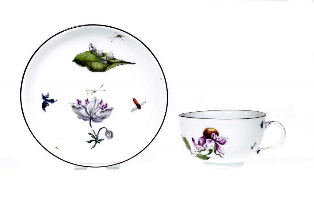 Appraisal: A MEISSEN TEACUP AND SAUCER enamelled with lily-of-the-valley and scattered