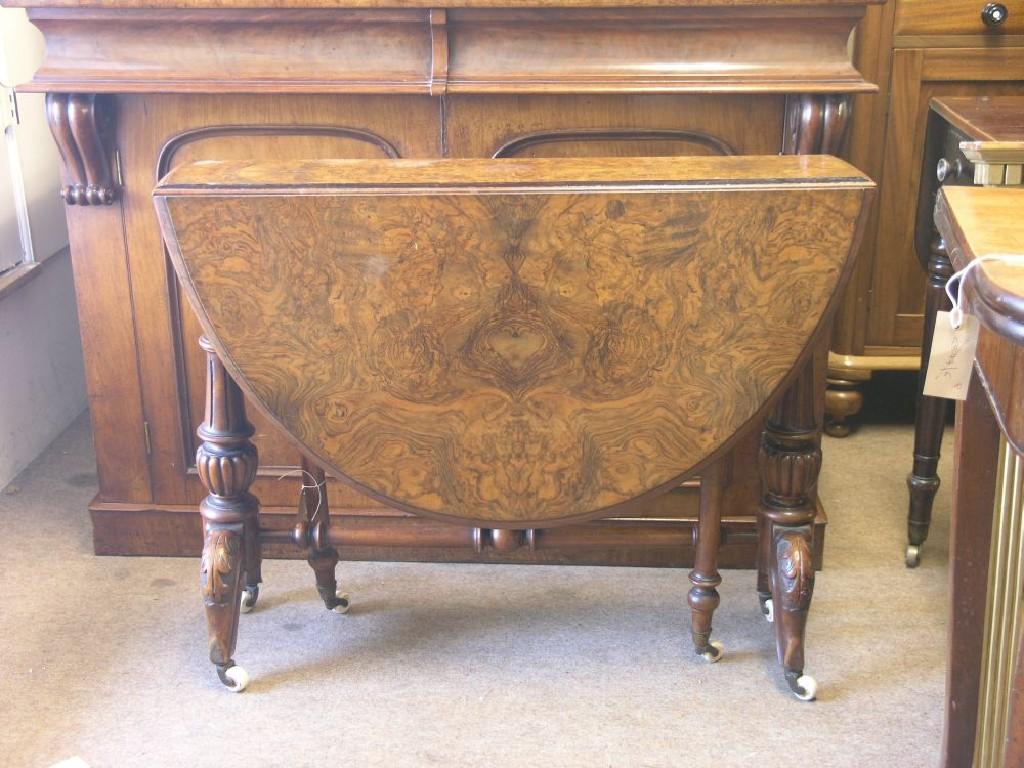 Appraisal: A Victorian burr walnut veneered Sutherland table quarter-veneered top on