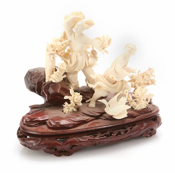 Appraisal: A carved ivory figural group mounted on stand Circa minor