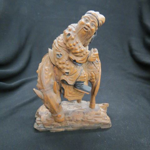 Appraisal: Chinese Carved Wooden Figurine horse and rider naturalistic base tall