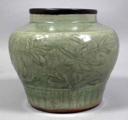 Appraisal: A Chinese celadon coloured porcelain jar with metal rim moulded