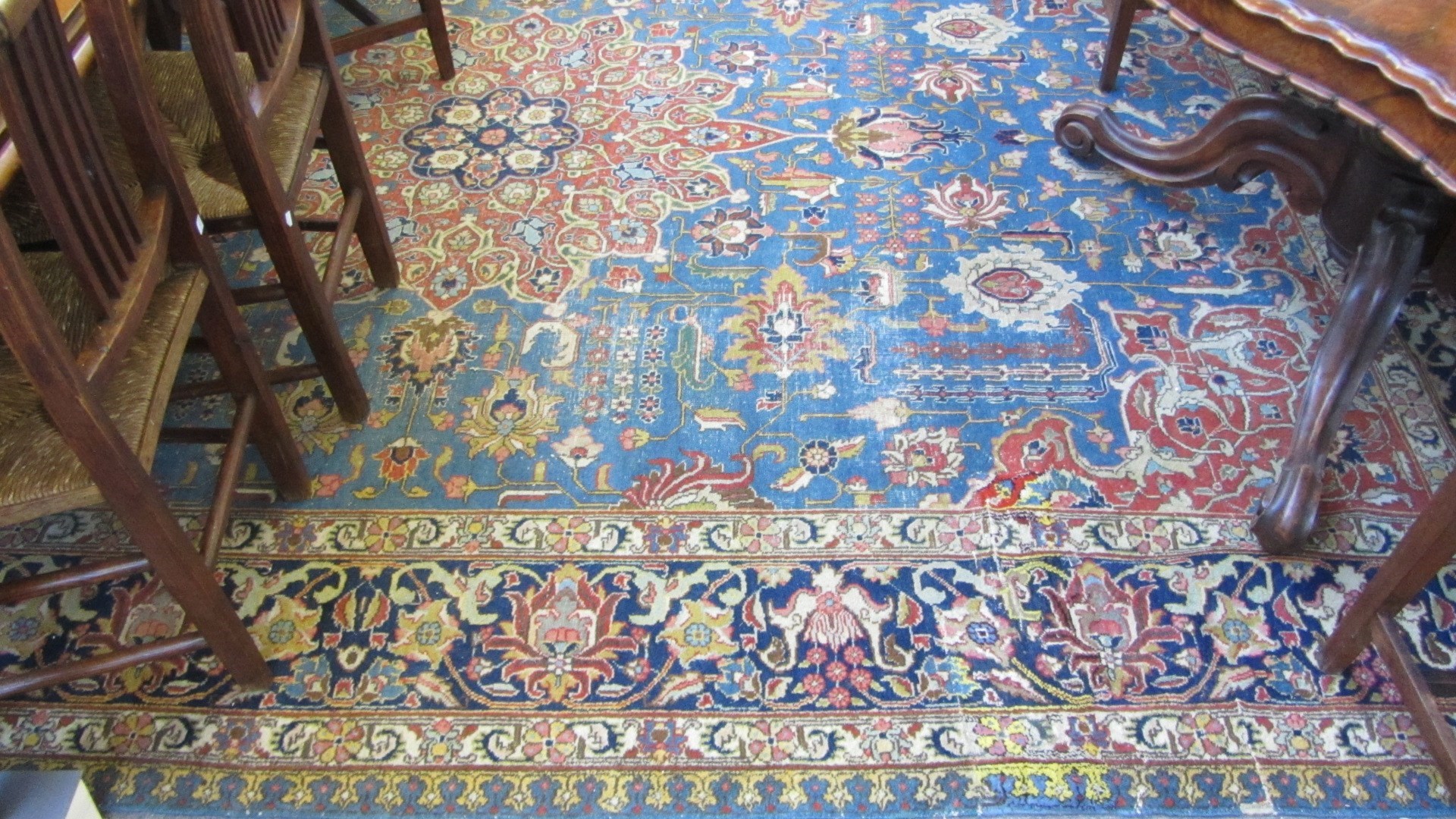 Appraisal: A Tabriz carpet Persian the indigo field with a madder