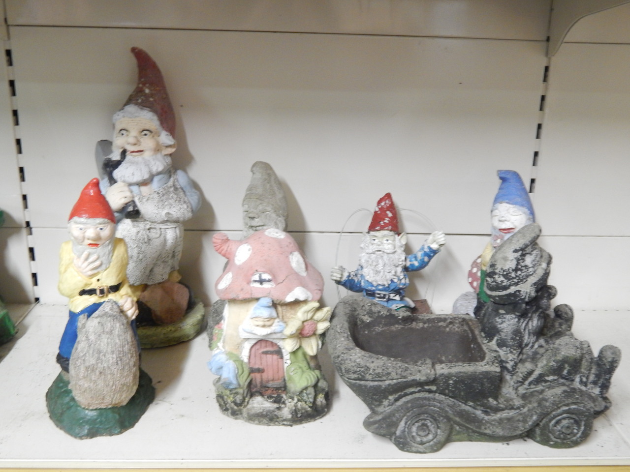 Appraisal: Seven composition garden gnomes etc in various poses to include