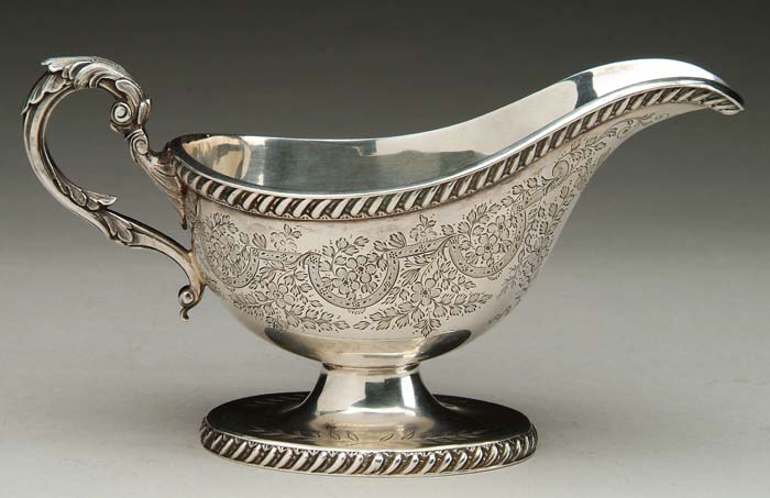 Appraisal: SHEFFIELD SILVER PLATED FOOTED SAUCE BOAT Fine scroll handle with