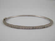 Appraisal: A white metal tests carat gold diamond bangle approx mm