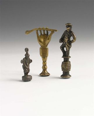 Appraisal: A Victorian brass pipe tamper of a hand holding a