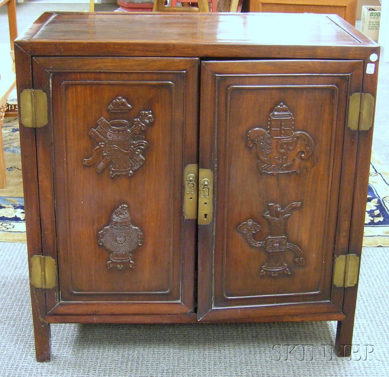 Appraisal: Chinese Export Carved Hardwood Two-Door Cabinet the divided interior fitted