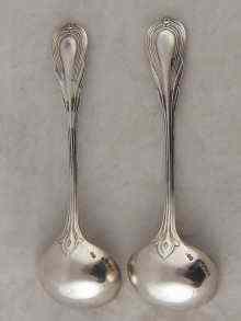 Appraisal: A pair of lily pattern silver sauce ladles maker's mark