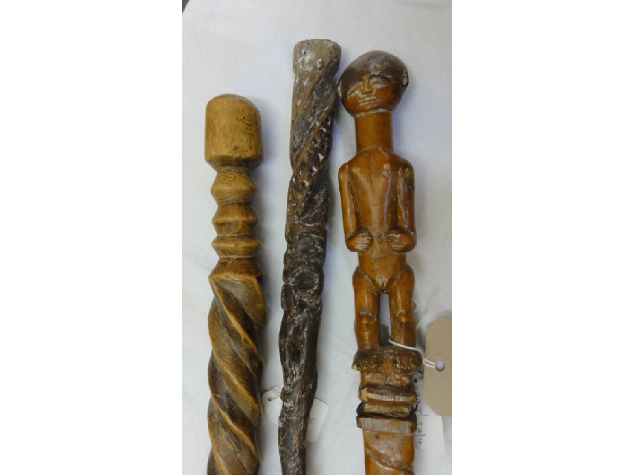 Appraisal: Three West African staffs one with a carved finial handle