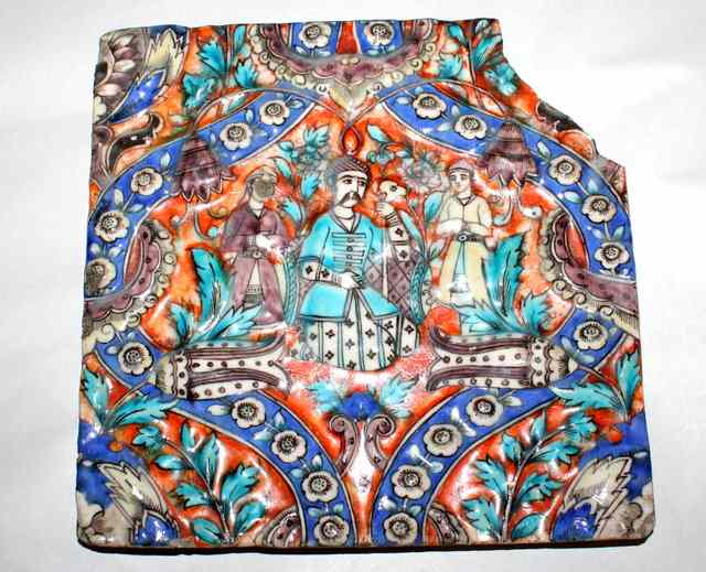 Appraisal: A PERSIAN POTTERY TILE decorated figures with polychrome glaze one