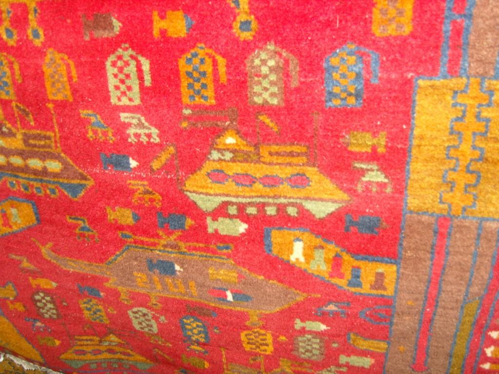 Appraisal: A red ground eastern wool rug with stylised decoration including