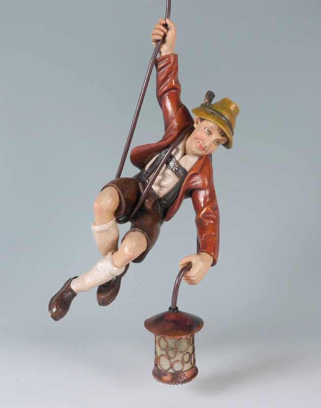 Appraisal: A WHIMSICAL FIGURAL BLACK FOREST MOUNTAIN CLIMBER LAMP Polychrome decorated