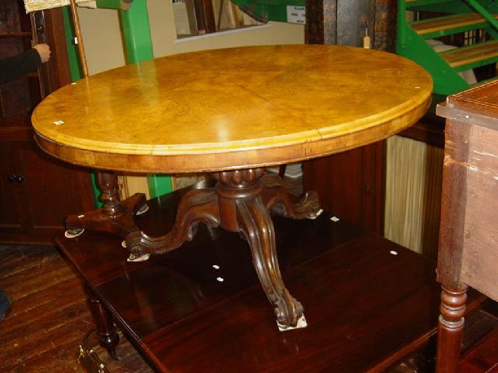 Appraisal: A Victorian walnut and figured walnut breakfast table of circular