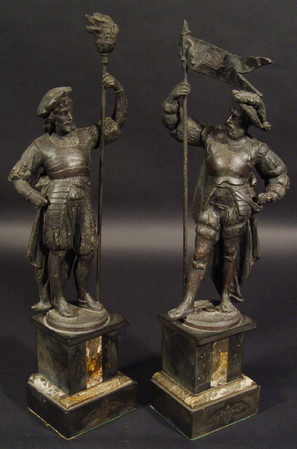 Appraisal: Pair of spelter figures clutching flagpoles and torches on black