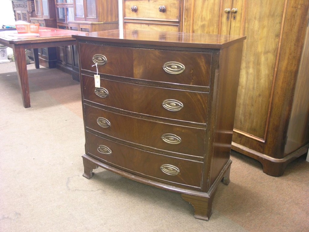 Appraisal: A reproduction mahogany bow-fronted chest four long drawers bracket feet