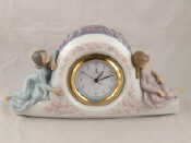 Appraisal: A ceramic clock by Lladro with quartz movement flanked with