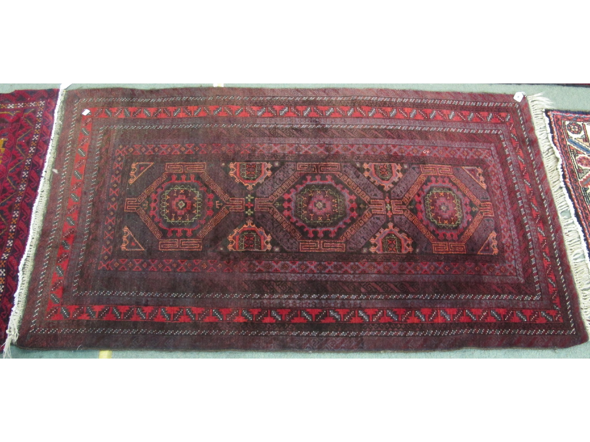 Appraisal: An Eastern rug on a red and orange ground x