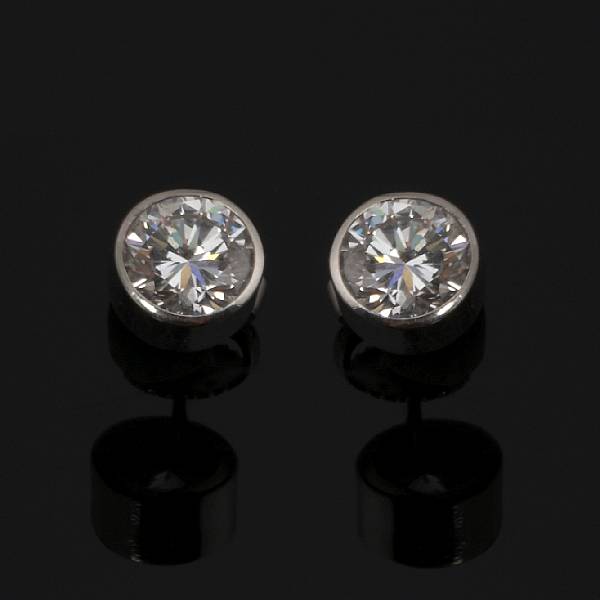 Appraisal: A pair of diamond stud earrings collet-set with two round