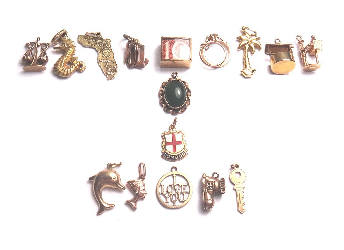 Appraisal: Sixteen mostly ct gold pendants and charms including a palm