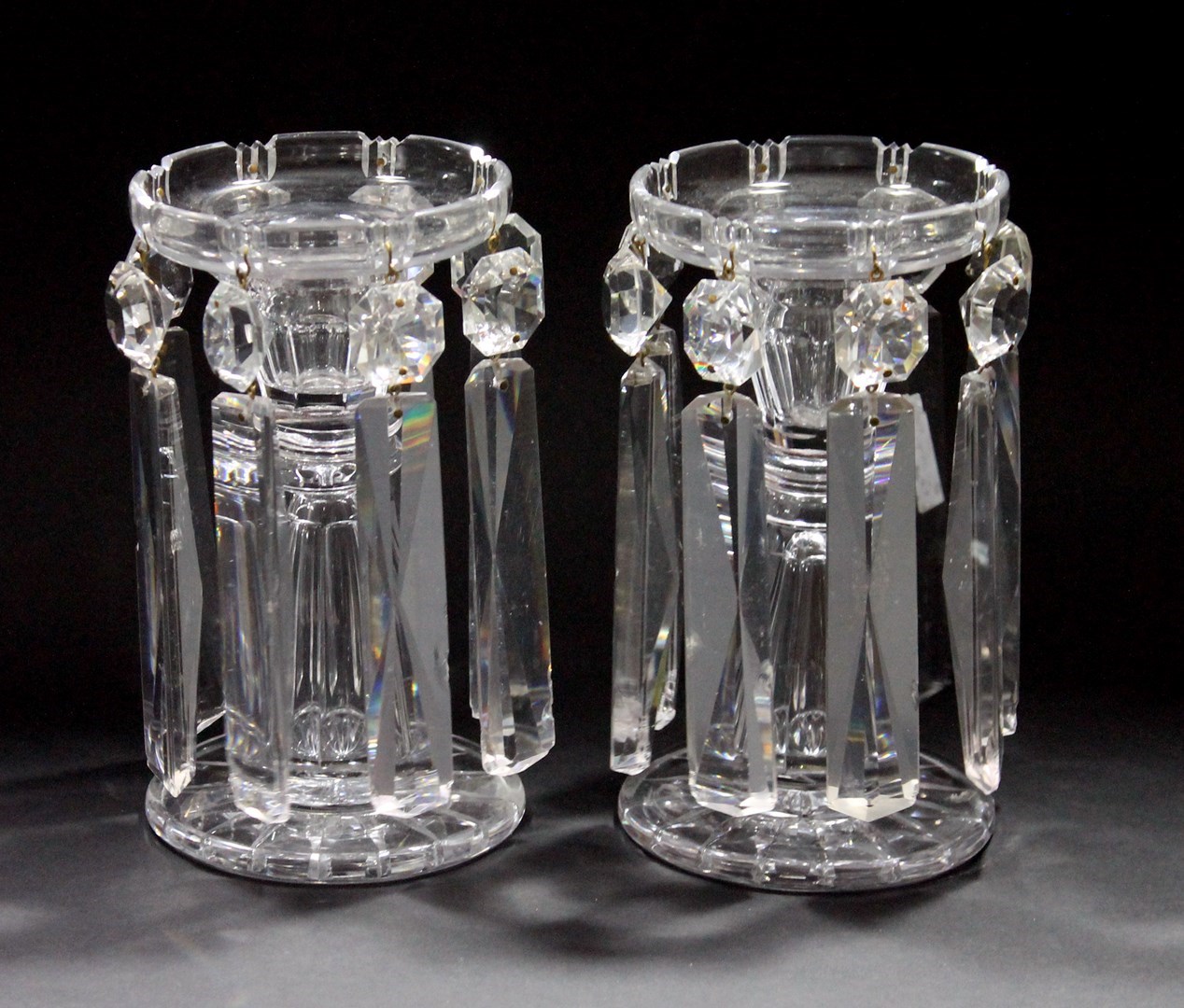 Appraisal: A pair of Victorian cut glass lustre candlesticks the circular