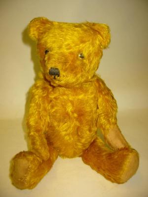 Appraisal: A pre war teddy bear straw filled covered in dark