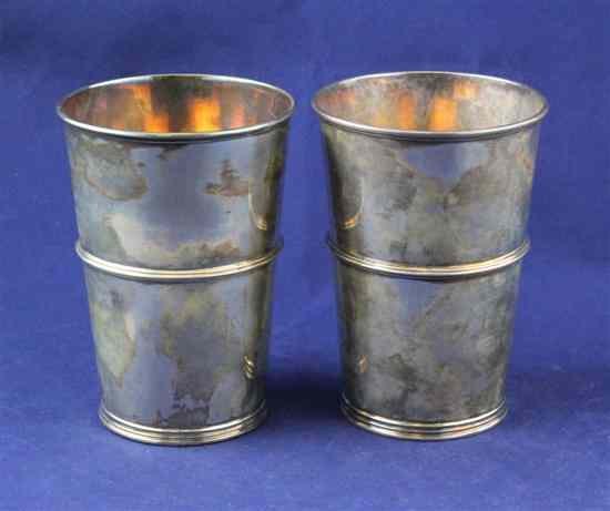 Appraisal: A pair of Edwardian silver beakers with banded girdle and