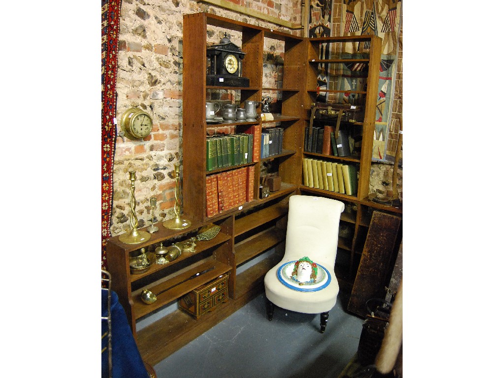 Appraisal: A Cotswold school stepped open corner bookcase with adjustable shelves