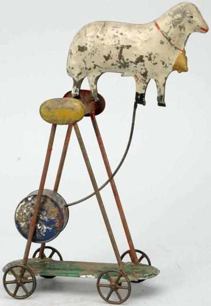 Appraisal: Early Tin Sheep Balancing Toy on Wheels American Circa late