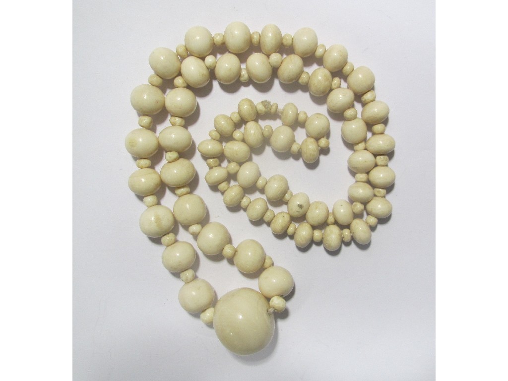 Appraisal: Long string of graduated ivory beads with the largest bead