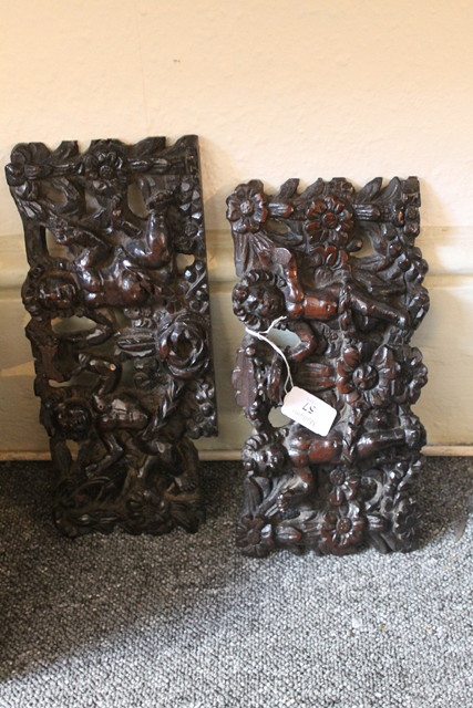 Appraisal: A PAIR OF CARVED ROSEWOOD PANELS each in the form