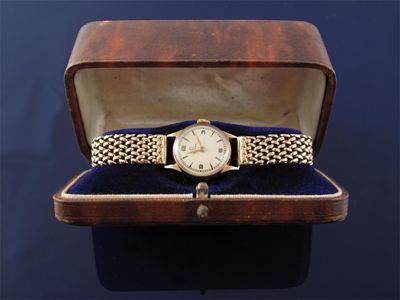 Appraisal: A gold wrist watch by Omega Gold expanding band Case