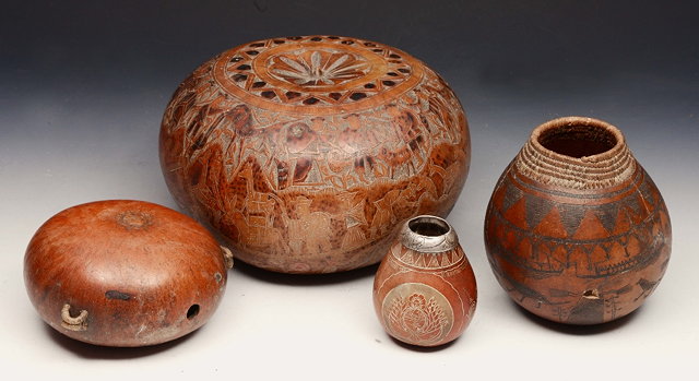 Appraisal: A SOUTH AMERICAN CARVED GOURD finely detailed incised figure and