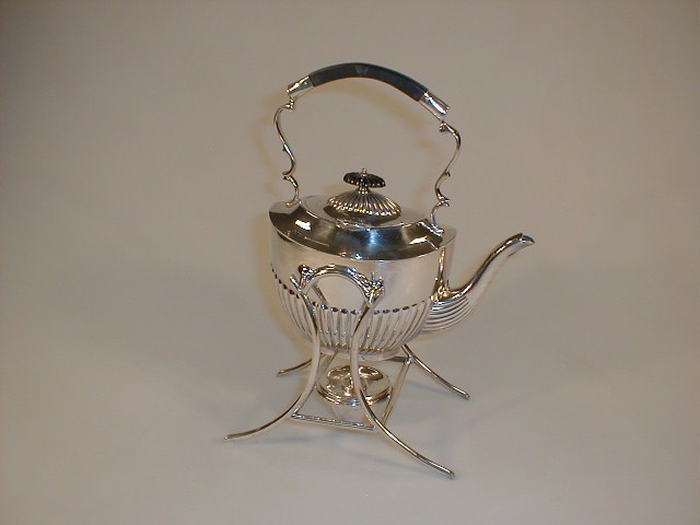 Appraisal: An electroplate part reeded spirit kettle on warming stand