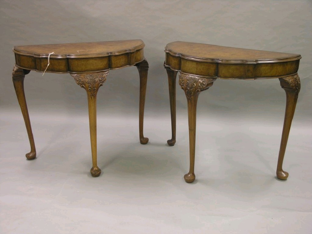 Appraisal: A pair of burr walnut veneered side tables lobed half-round