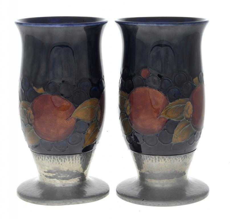 Appraisal: A PAIR OF MOORCROFT TUDRIC PEWTER-MOUNTED POMEGRANATE VASES DESIGNED BY