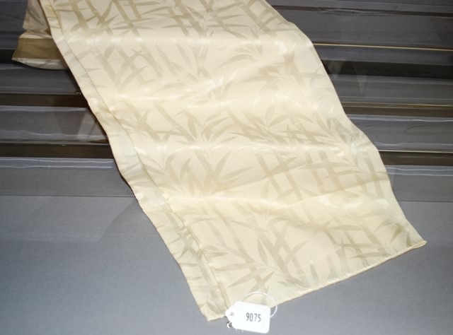 Appraisal: Cream on cream double faced bamboo design silk scarf -