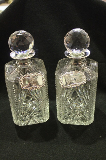 Appraisal: TWO GLASS DECANTERS with silver mounted necks and bulbous stoppers