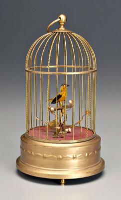 Appraisal: German singing bird in brass cage yellow bird on perch