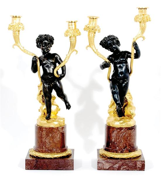 Appraisal: Pair French style parcel-gilt bronze and marble candelabra jovial cherubs