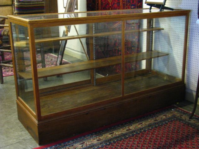 Appraisal: Antique oak and glass showcase with two sliding clear glass