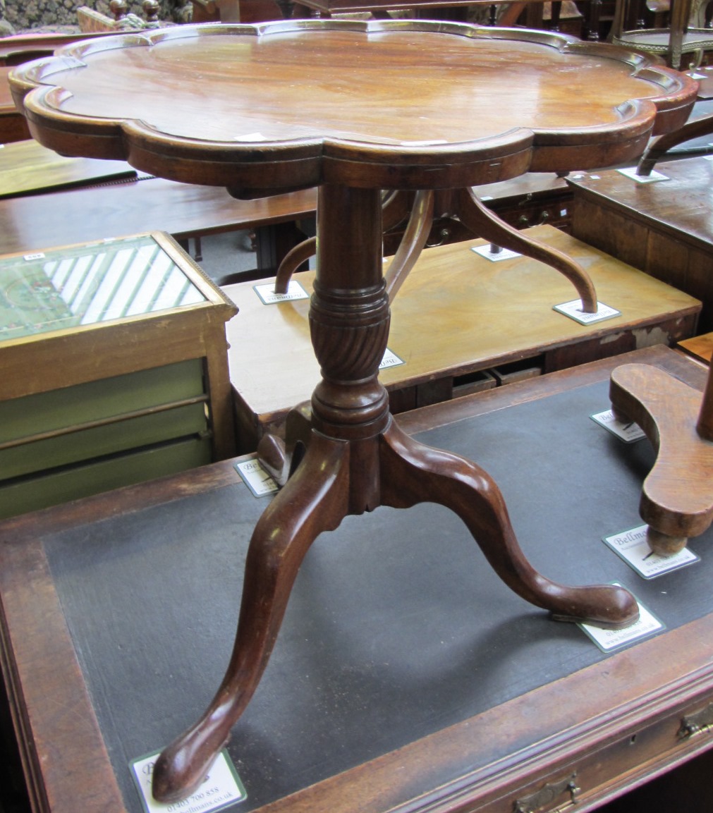 Appraisal: A George III and later mahogany occasional table the scalloped